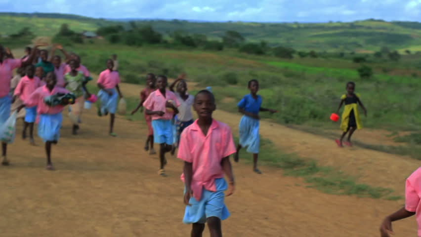 KENYA, AFRICA - CIRCA 2011: Children running alongside a car.