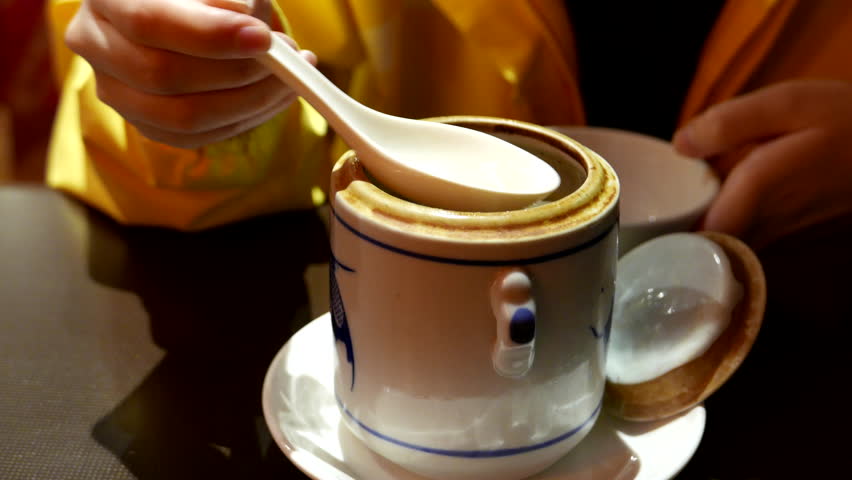 Close up womna drinking seafood soup inside Chinese restaurant with 4k resolution
