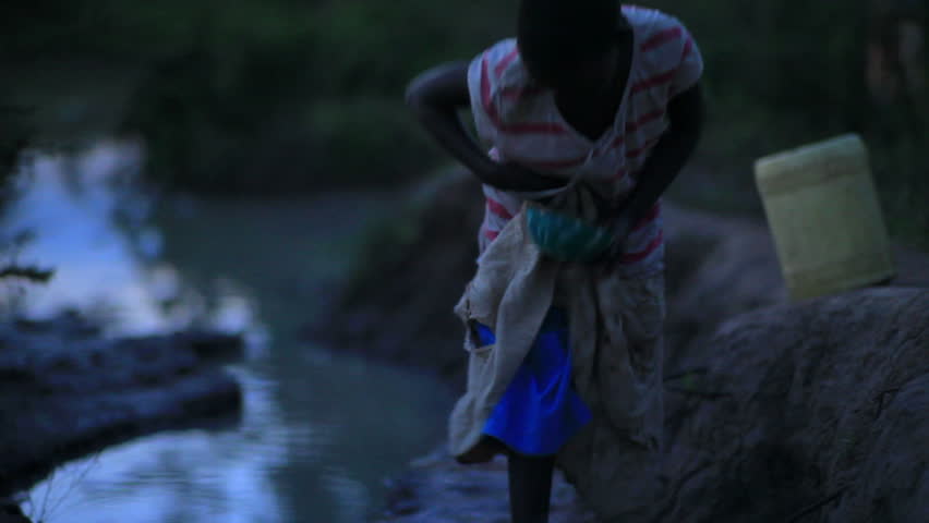 KENYA, AFRICA - CIRCA 2011: A child gathering water near a village in Kenya two