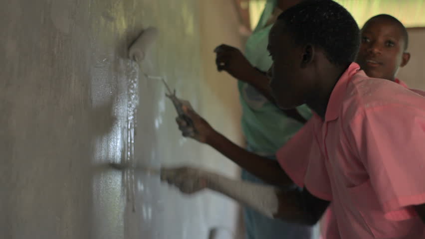 KENYA, AFRICA - CIRCA 2011: Children painting a wall.