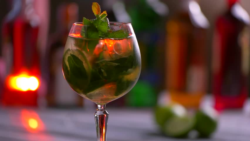 Glass of beverage is rotating. Coktail with mint and lime. Chilled alcohol drink. Try the hugo cocktail. Royalty-Free Stock Footage #17245963