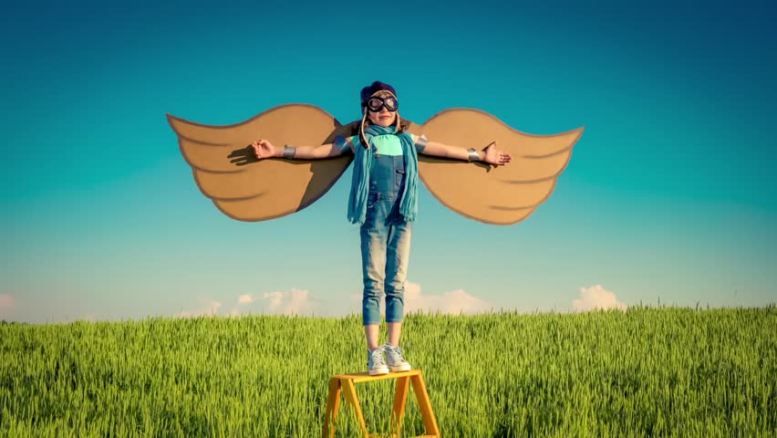 Happy kid playing outdoors in summer field. Travel and vacation concept. Imagination and freedom. Slow motion | Shutterstock HD Video #17246254