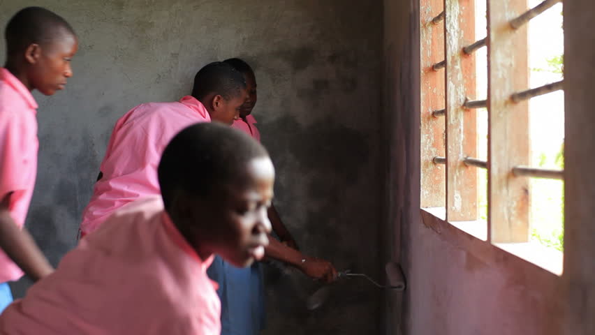 KENYA, AFRICA - CIRCA 2011:  Children painting the inside of a building in