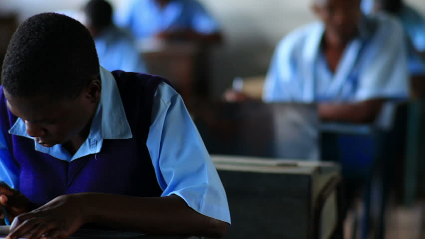 KENYA, AFRICA - CIRCA 2011: Front view of student doing classwork in Kenya,