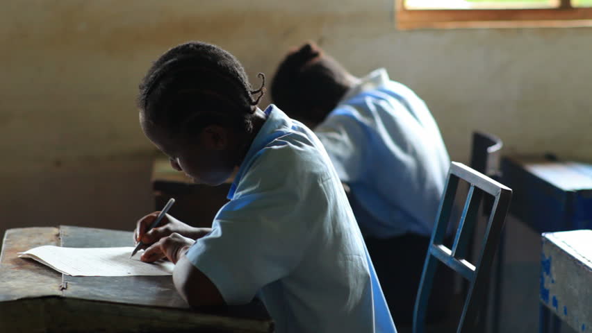KENYA, AFRICA - CIRCA 2011: Side view of school boys and girls in a classroom in
