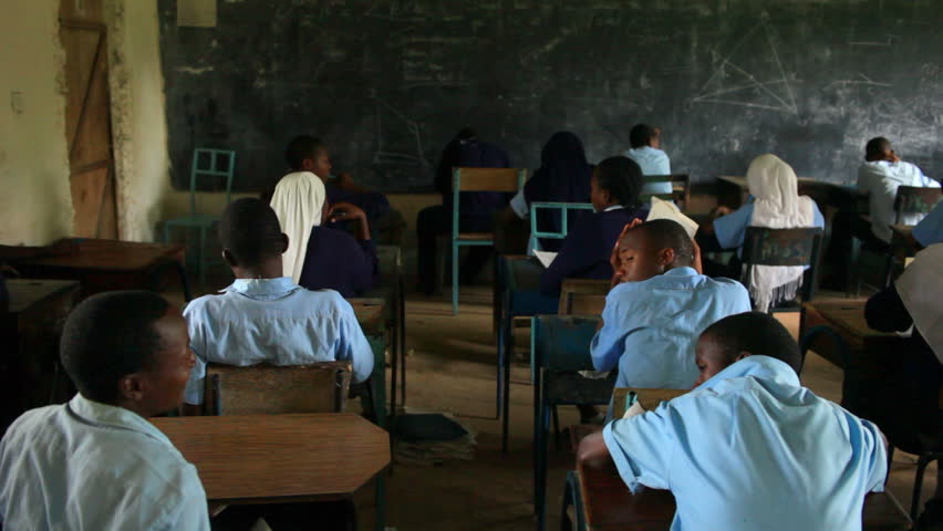 KENYA, AFRICA - CIRCA 2011: Back view of school boys and girls in a classroom in