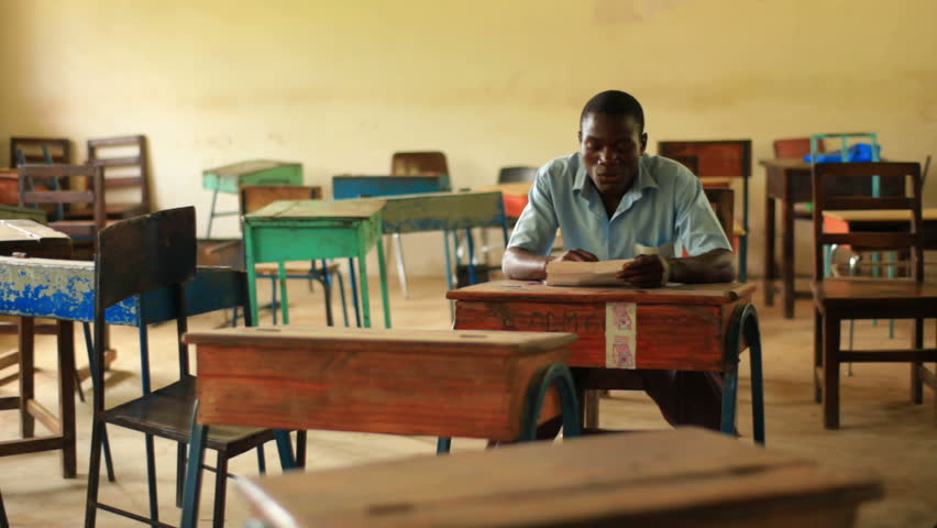 KENYA, AFRICA - CIRCA 2011:  Shot of school boy doing homework in empty