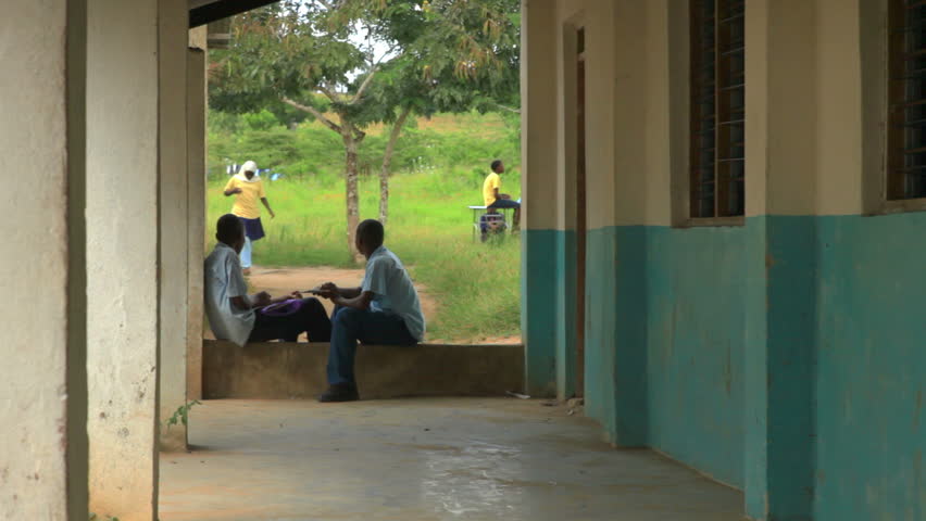 KENYA, AFRICA - CIRCA 2011: Shot of two school boys studying in an outside