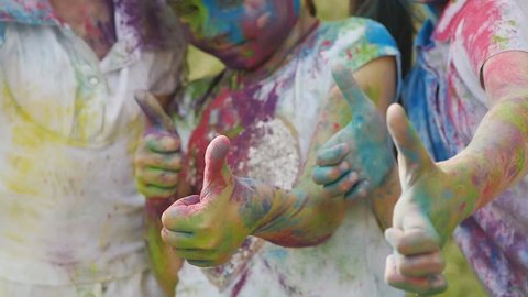cute european child girls celebrate Indian holi festival with colorful paint