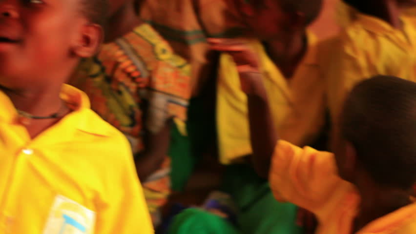 KENYA, AFRICA - CIRCA 2011: Close up of boy raising his hand in a full classroom