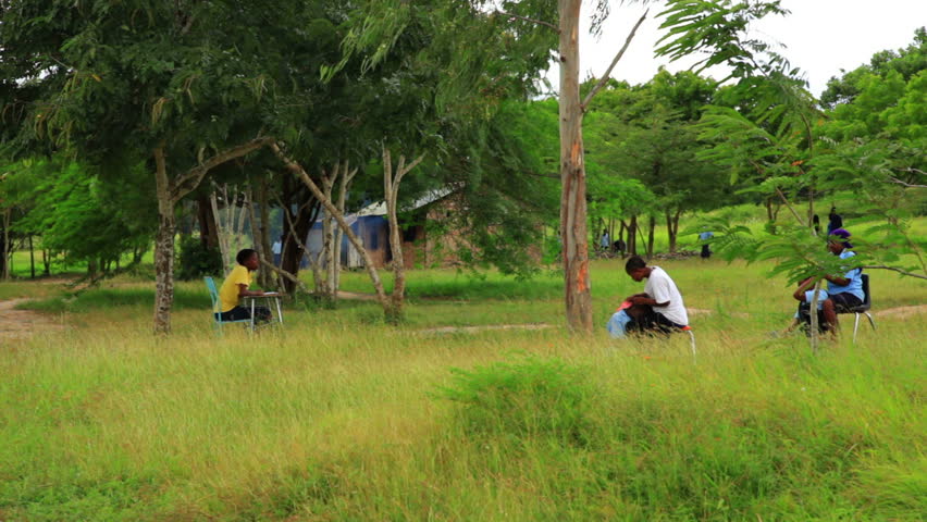 MOMBASSA, KENYA, AFRICA - CIRCA 2011: Students and workers taking a break from