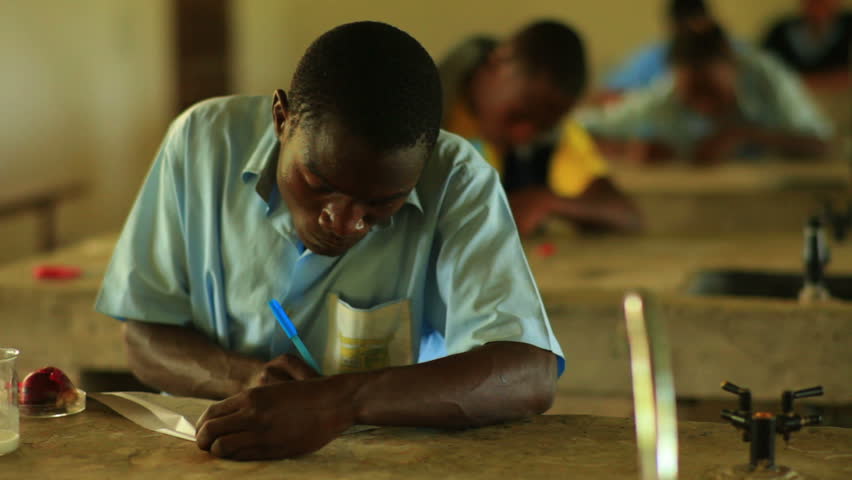 KENYA, AFRICA - CIRCA 2011: School boy doing chemistry in Kenya, Africa.