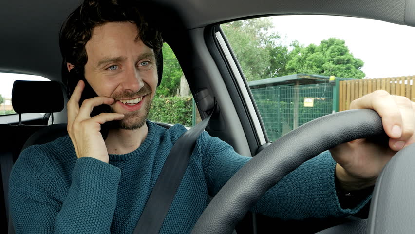Cool happy man laughing talking on the phone while driving car 4K