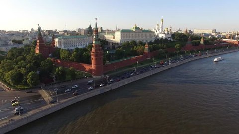 Flight over Moscow Kremlin near Red square. City center, downtown, river. Day road traffic. Unique aerial FPV Drone shot. High altitude. Warm sunset. UltraHD 4K