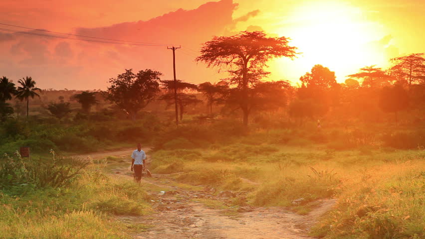 KENYA, AFRICA - CIRCA 2011: School boy walking at dawn in Kenya, Africa.