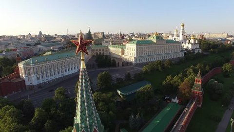 Flight over Moscow Kremlin Star near Red square. City center, downtown. Day road traffic. Unique aerial FPV Drone shot. High altitude. Warm sunset. UltraHD 4K