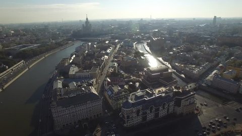 Old Moscow city center. Narrow small streets and classic buildings. Road traffic. Best sunset lighting. Aerial view, flight over. Morning. Mosocw river.