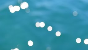 Bokeh water background. Bokeh sea ripple surface. Bokeh sun glare on the water surface. Blue sea water background. Bokeh water texture