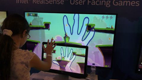 JERUSALEM, ISRAEL - APRIL 26, 2016: A child plays computer game with Intel's RealSense technology for facial, expression and Finger Gesture recognition, emotion tracking, during Geek PicNic festival