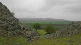 4k video of mountain landscape and fields on rainy day , Dobrogea, Romania