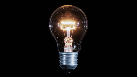 Tungsten light bulb lamp blinking over black background, macro view, loop ready Vídeo Stock