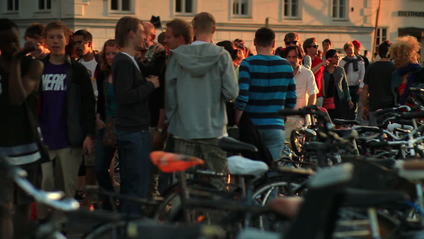 DENMARK - JULY 2010: Bicycle rack and a crowd of people walking in Copenhagen,