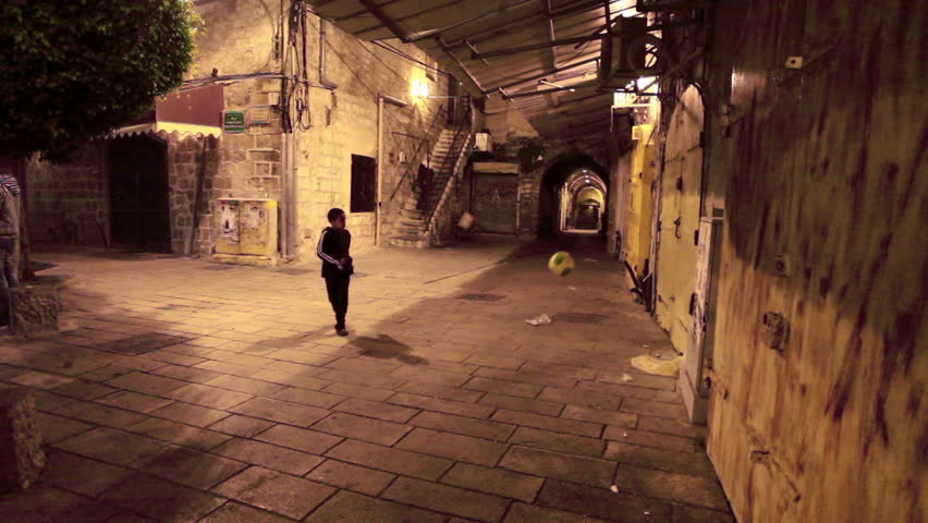 ISRAEL - FEB 2011: A little boy playing soccer by himself