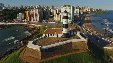Aerial view of Farol da Barra Lighthouse at sunset in Salvador, Bahia, Brazil. Dating from the year 1698, it is said to be the oldest lighthouse in South America.