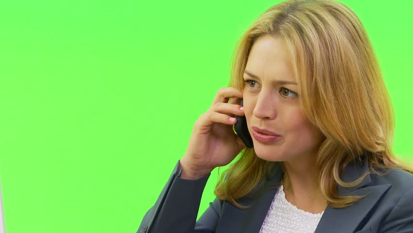 Close up of businesswoman talking on phone at desk