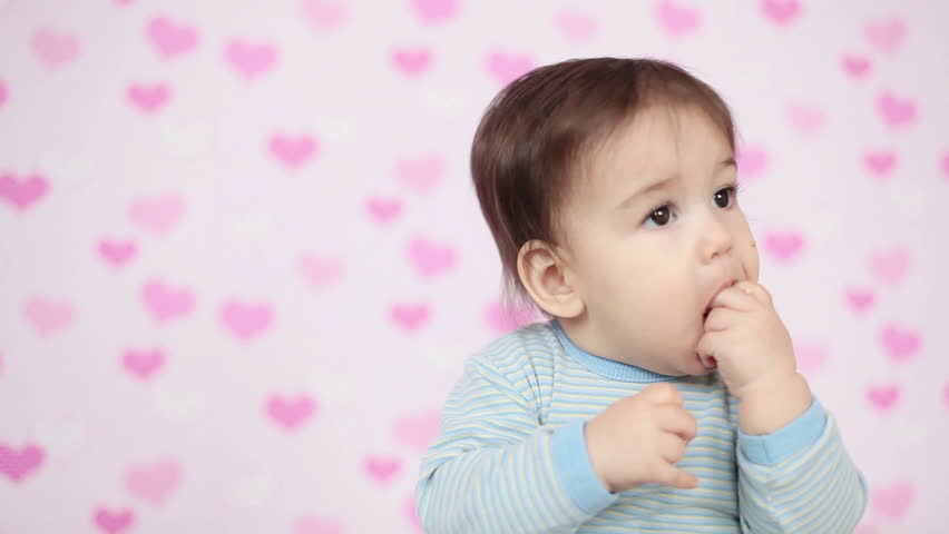 Closeup portrait of a baby boy eating a cookie