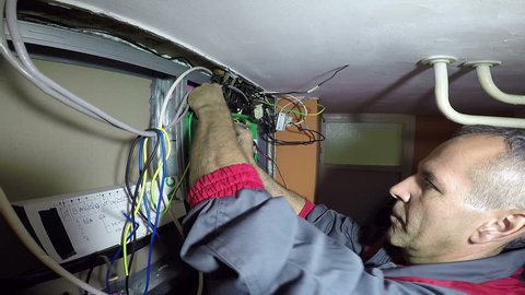 Electrician Turning On New Trip Switch Fuses in a Mains Fuse Box / Experienced electrician turning on the automatic circuit breakers HD1080p