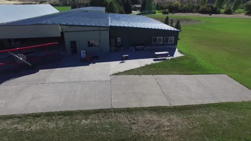 Aerial shot of two biplanes starting from the hangar