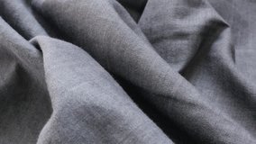 Dark gray fine textile jeans pattern gathers close-up  slow tilt 4K 3840X2160 UltraHD footage - Gray shirt denim surface texture 4K 2160p 30fps UHD tilting video
