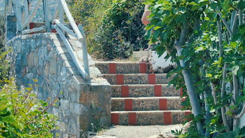Mom and girl down the stairs to the beach.