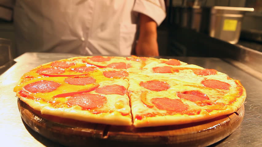 Chef cuts pizza with a special knife