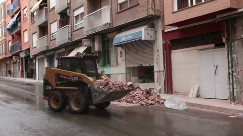 LORCA, SPAIN - MAY 20, 2011: Earth quake destruction in Lorca, Spain on May 20, 2011, several days after event. People work to cleanup and stabilize broken and cracked buildings.
