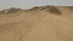 Aerial of sand dunes in a desert in Peru, South America. 4K Aerial Video footage near the city of Caral