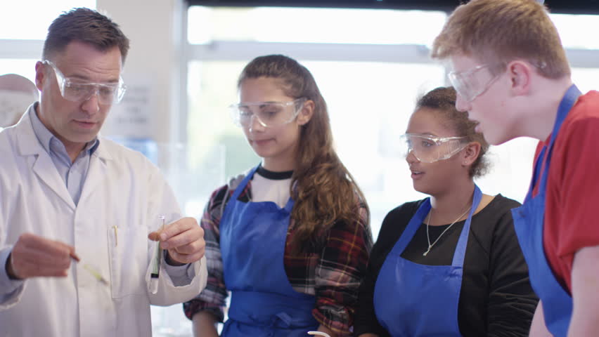 4K Teacher teaching group of students in school science class. Shot on RED Epic. UK - April, 2016