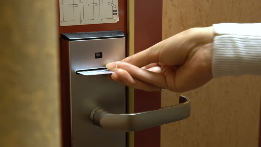 A young woman opens the door of his hotel room using an electronic key card. Royalty-Free Stock Footage #17295544