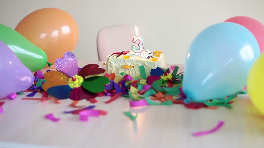 Empty table with cake and balloons