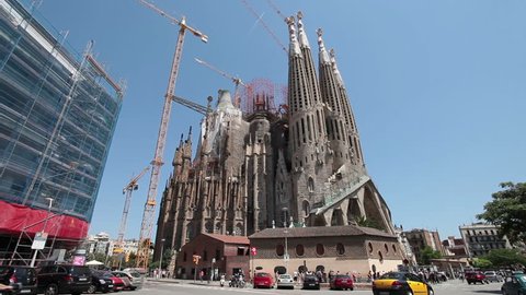 BARCELONA, SPAIN - MAY 21 2011 (Timelapse): Cathedral Sagrada Familia famous church and landmark with tourists and locals in city park in Barcelona, Spain on May 21, 2011. Traffic on road fast timelapse.