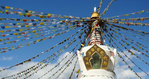 4k buddhist white stupa & flying prayer flags with blue sky background,shangrila yunnan,china. gh2_10484_4k