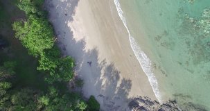 Aerial drone footage of ocean waves reaching shore. Sea in Rayong, Thailand. UHD 4K video.