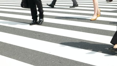 Tokyo - May 2016: People walking on cross walk. Close up of feet. Shinjuku. 4K resolution