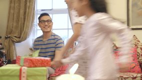 Excited siblings on Christmas morning. They both run up to their mother for a cuddle, before receiving presents from both their parents. - Powered by Shutterstock - Get 15% off with code: PIKWIZARD15