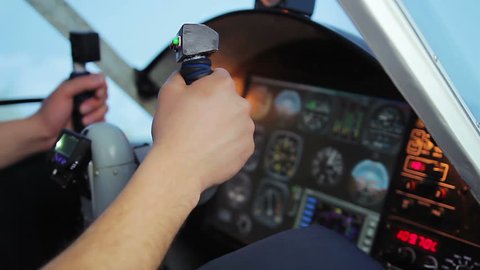 Pilot's hand knocking on breakdown cockpit panel, flight control system error