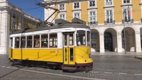 LISBON, PORTUGAL - MARCH 02, 2016: Historic tram passes Commercial Square along  Rua Augusta to the Arch. The tramway has been in operation since 1873.