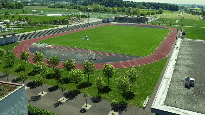 Young woman running around the track