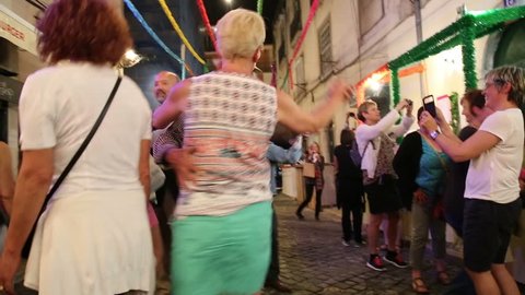 LISBON - JUNE 12,2016: Local man dance with tourist in Lisbon street festival