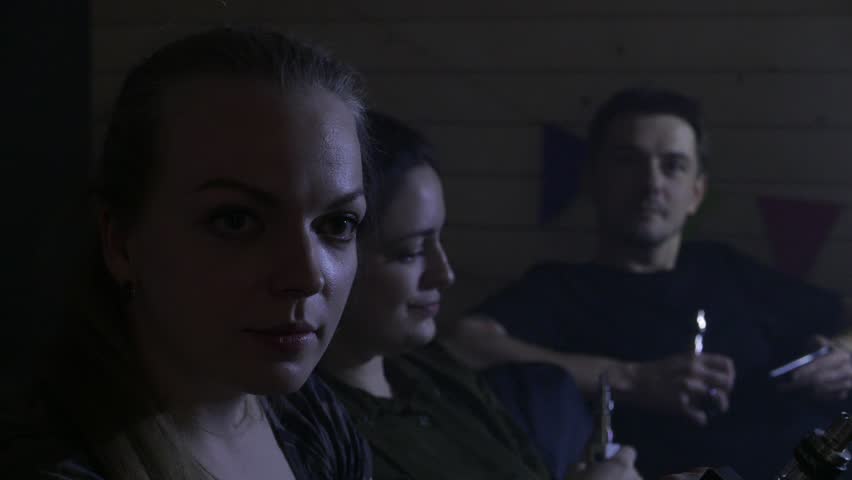 A group of people vaping, inhaling and exhaling large clouds of smoke and having fun together.  Company of good friends. 4K UHD.